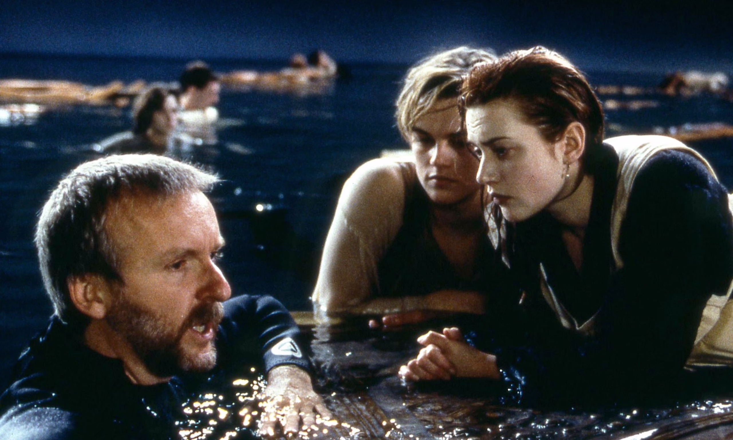Director James Cameron with Kate Winslet and Leonardo DiCaprio on the Titanic door during filming